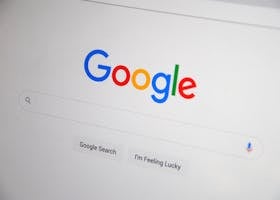 Close-up of the Google homepage on a screen showing search options.